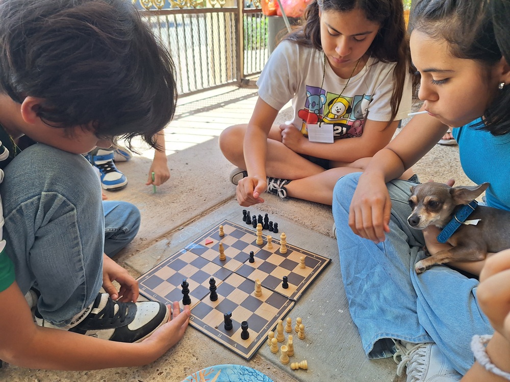 Niños jugando ajedrez en un taller.